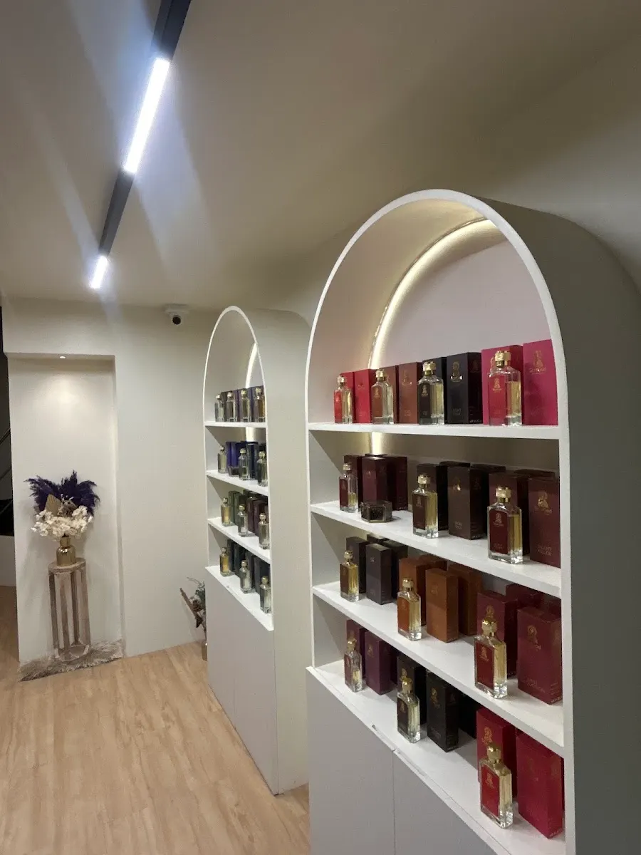 Backlit arch shelf lined with StarGod perfume bottles